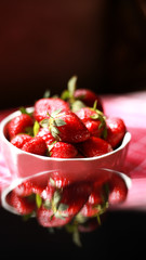 Group of strawberry in a white bowl, Strawberry in red background,