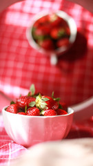 Group of strawberry in a white bowl, Strawberry in red background,