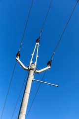 Distribution of electricity. Pylons of a power line with blue sky. Modern pole power line. Energy...