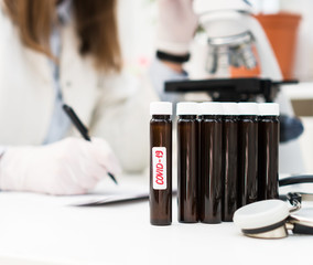 Scientist in laboratory making notes. Covid-19 concept.
