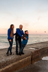 family walk on the sea coast in spring