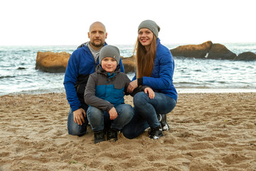 family walk on the sea coast in spring