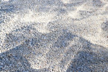 Gravel, background, shadow, light. Reflection and shadows on a gravel background.