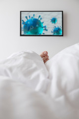 Corona virus concept of self isolation or carantine: Toe of sick person lying down in bed and...