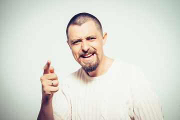 Young man showing his index finger towards the camera