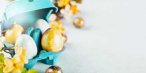 Easter background with Easter eggs and spring flowers. Copy space. 