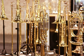 A view of several trombone instruments on display at a local music store.