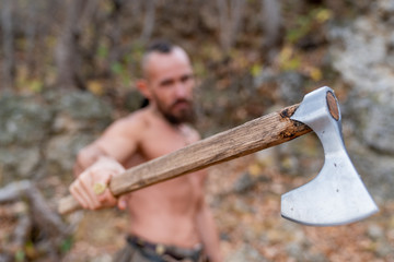 topless viking holding a battle ax in his hand