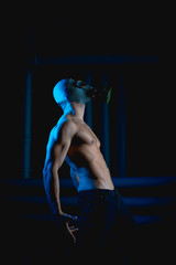 guy in gas mask looks right, hands back