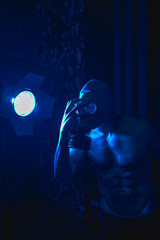 man in gas mask under blue neon light