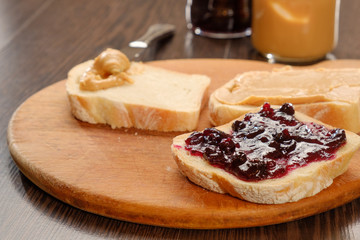 peanut butter sandwich with jam on cutting board