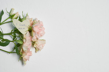 roses on a white background and a card with a congratulation to mother's day.