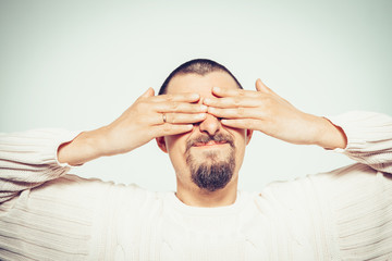 Man closes eyes with her hands