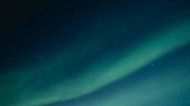 Northern Lights, polar light or Aurora Borealis in the night sky over the arctic landscape of Senja island in northern Norway. Time lapse video.