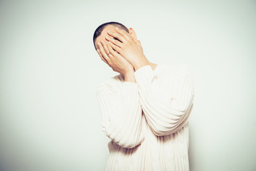 Man covering his face
