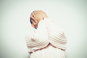 Man covering his face