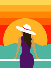 Woman in a hat standing on the seashore against the backdrop of the sun