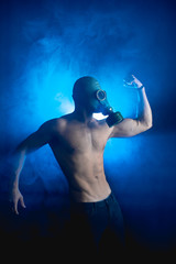 man posing before camera in blue smoke