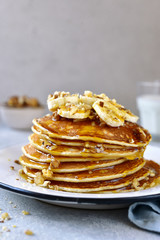 Homemade delicious banana pancakes with walnuts and maple syrup.