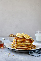 Homemade delicious banana pancakes with walnuts and maple syrup.