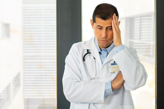 Cropped Shot Of A Doctor Looking Stressed Out At Hospital