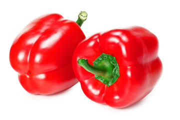 two red sweet bell peppers isolated on white background
