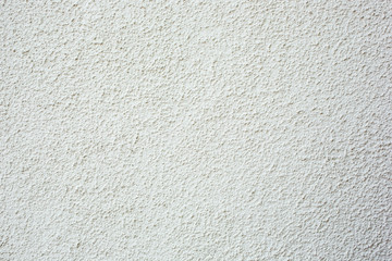 A background of pebble dash style stucco wall texture.