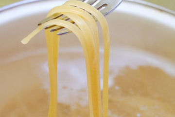 Spaghetti in pan cooking in boiling water, cooking pasta