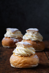 Semlor, traditional scandinavian cream filled cardamom buns with almond paste