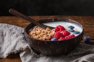 Yogurt bowl with granola, blueberries and raspberries
