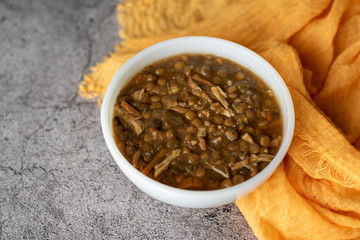 A bowl of lentil soup with chicken, Mediterranean soup with thick stew like broth. 