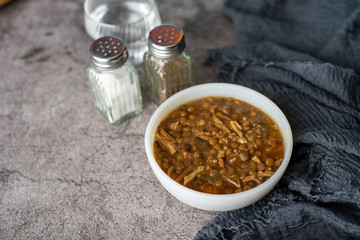 A bowl of lentil soup with chicken, Mediterranean soup with thick stew like broth. 