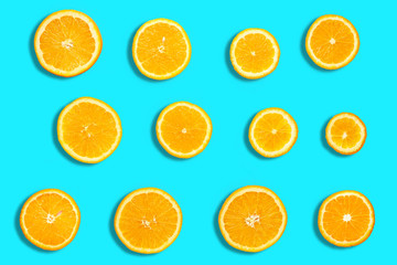 Colorful fruit pattern of fresh orange and grapefruit slices on blue background. From top view