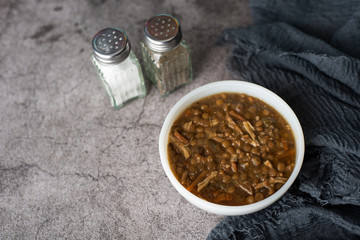 A bowl of lentil soup with chicken, Mediterranean soup with thick stew like broth. 