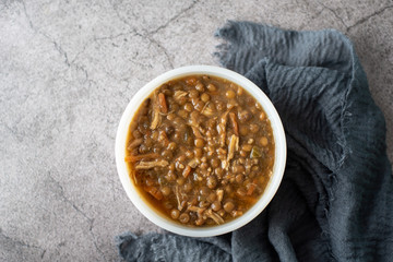 A bowl of lentil soup with chicken, Mediterranean soup with thick stew like broth. 