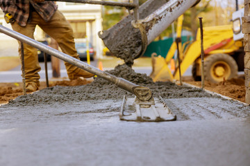 Worker working for concrete pavement for ground construction - obrazy, fototapety, plakaty