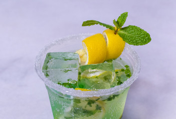 Lemon And Mint Mojito Cocktail In A Plastic Cup With Decoration 