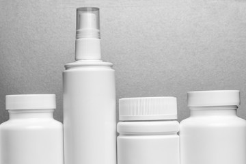 photo of four plastic cans for package pills and vitamins and antiseptic spray for protection...