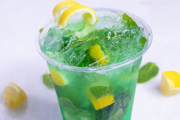 Lemon And Mint Mojito Cocktail In A Plastic Cup With Decoration 