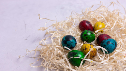 Close up of easter little eggs in straw, save space