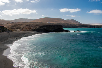 Aerial view of Black Sandy Beach, Coast of Atlantic Ocean and Cliffs in Ajuy, Furteventura, Canary Islands, Spain 
