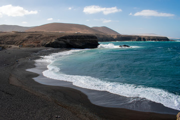 Fototapeta na wymiar Aerial view of Black Sandy Beach, Coast of Atlantic Ocean and Cliffs in Ajuy, Furteventura, Canary Islands, Spain 