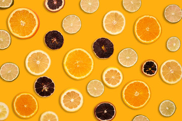 Abstract background of citrus slices. Orange paper background. Top view.