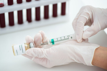Test tubes with blood sample Covid-19 coronavirus. Vaccine and syringe injection It use for...
