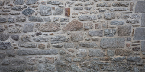 Grey stone wall old stones gray assembled texture ancient background