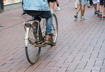 Man rides a bike on the street, detail