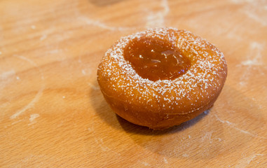 fresh donut with jam with wooden background