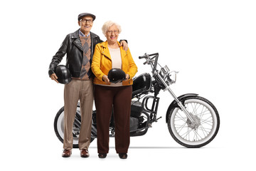 Senior couple standing next to a custom made chopper motorbike