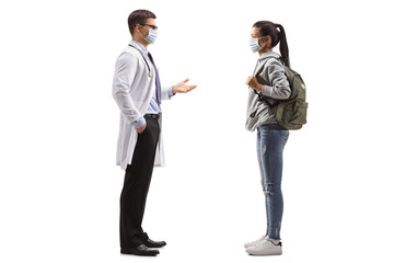 Male doctor and a female student wearing medical masks and talking