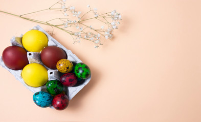 Easter symbol, on a peach background white flowers and Easter eggs